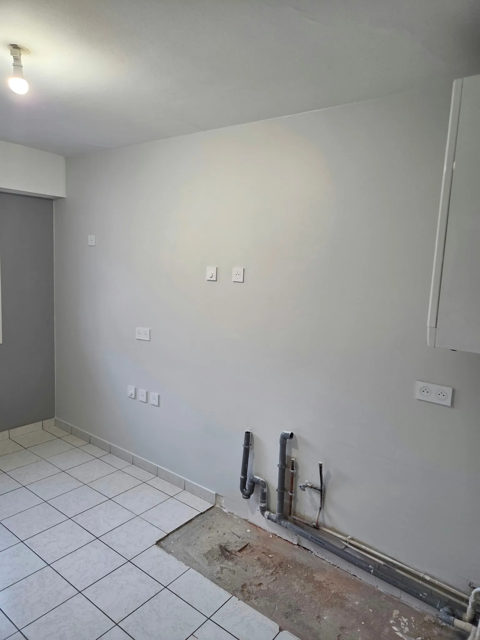 Le même mur rebouché, enduit et repeint en blanc
